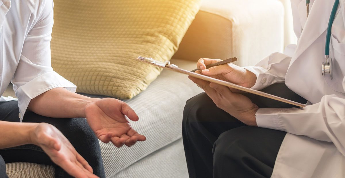 Doctor-consulting-with-patient-indoors Doctor-consulting-with-patient-indoors