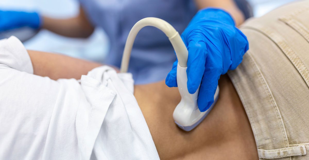 Doctor-performing-ultrasound-scan-on-patient-abdomen Doctor-performing-ultrasound-scan-on-patient-abdomen