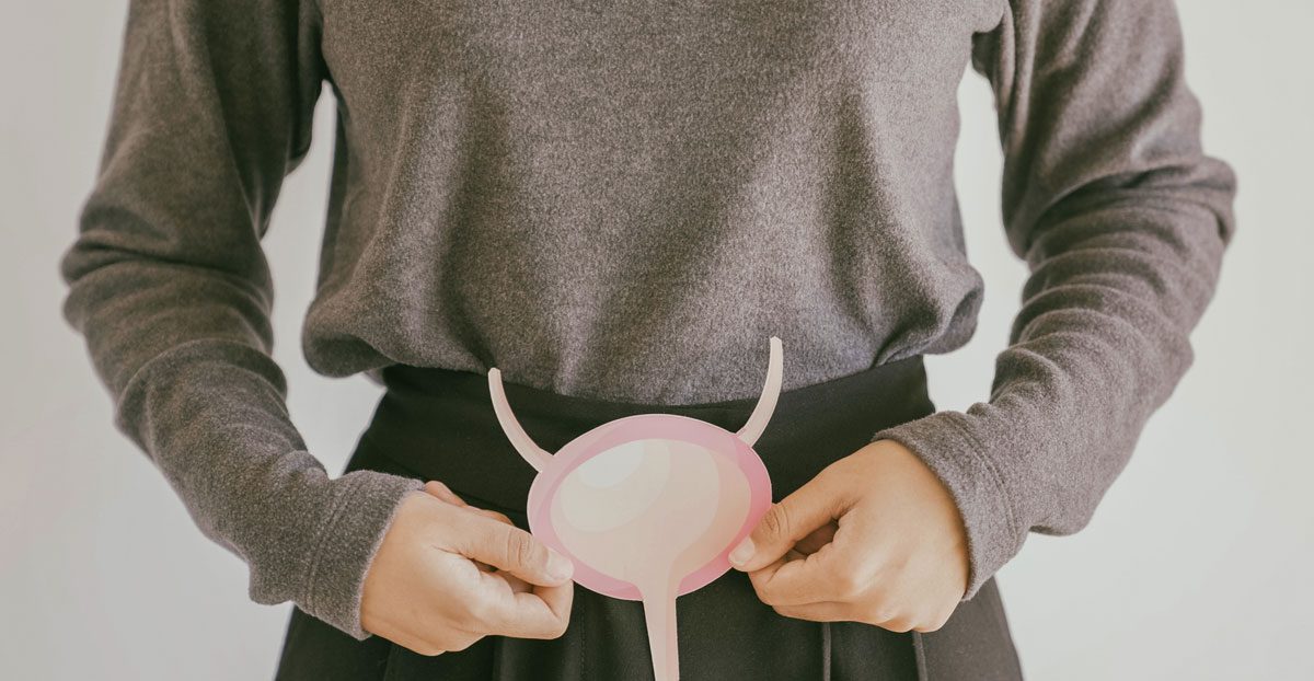 Person-holding-bladder-cutout-in-front-of-lower-abdomen